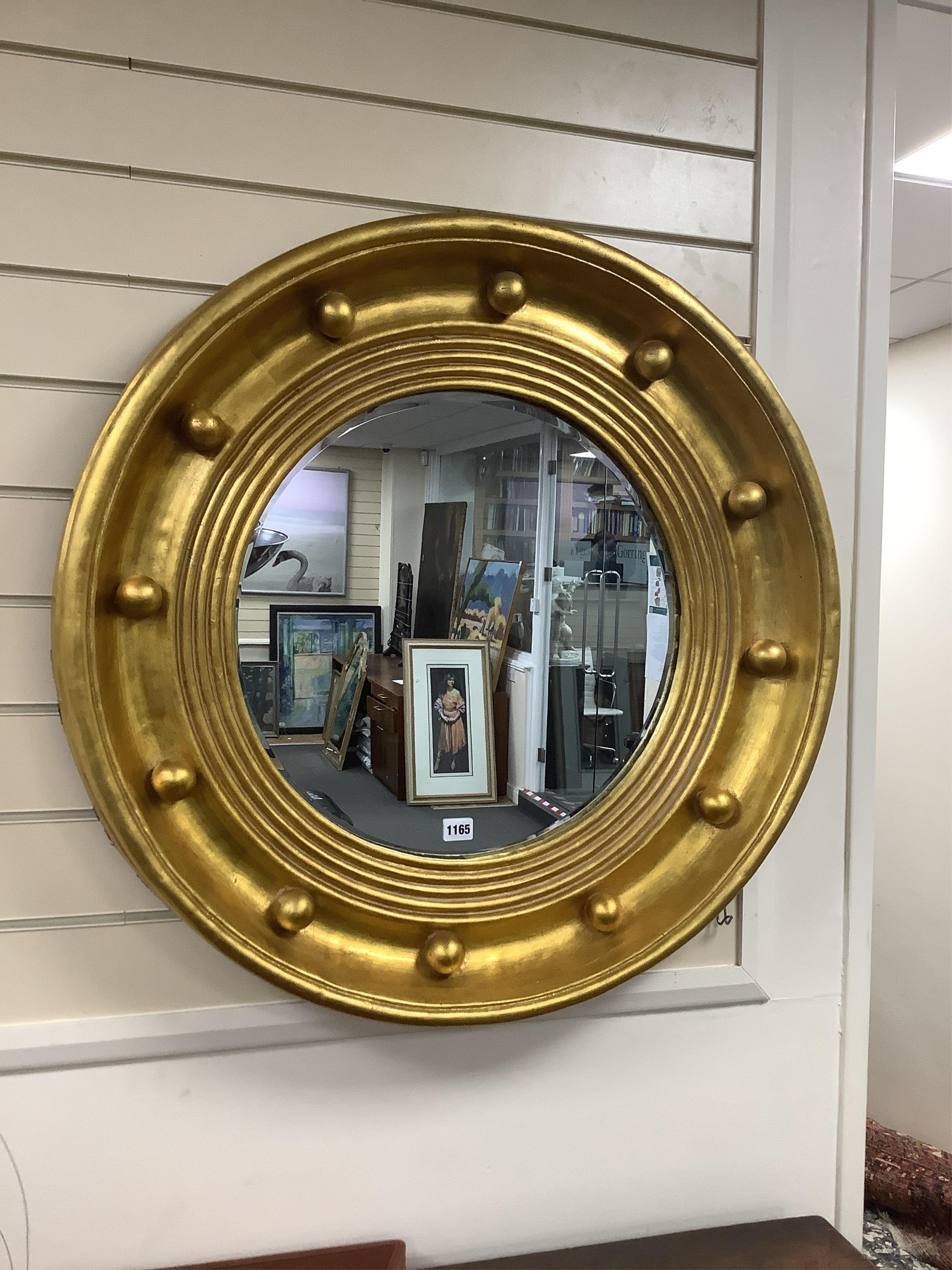 A Regency style circular gilt composition wall mirror, diameter 77cm. Condition - good